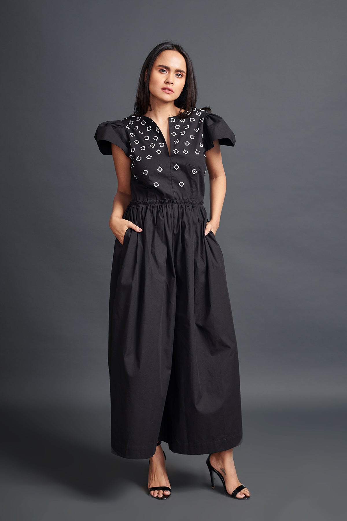 Image of BLACK BACKLESS JUMPSUIT IN COTTON BASE WITH CUTWORK EMBROIDERY. From savoirfashions.com