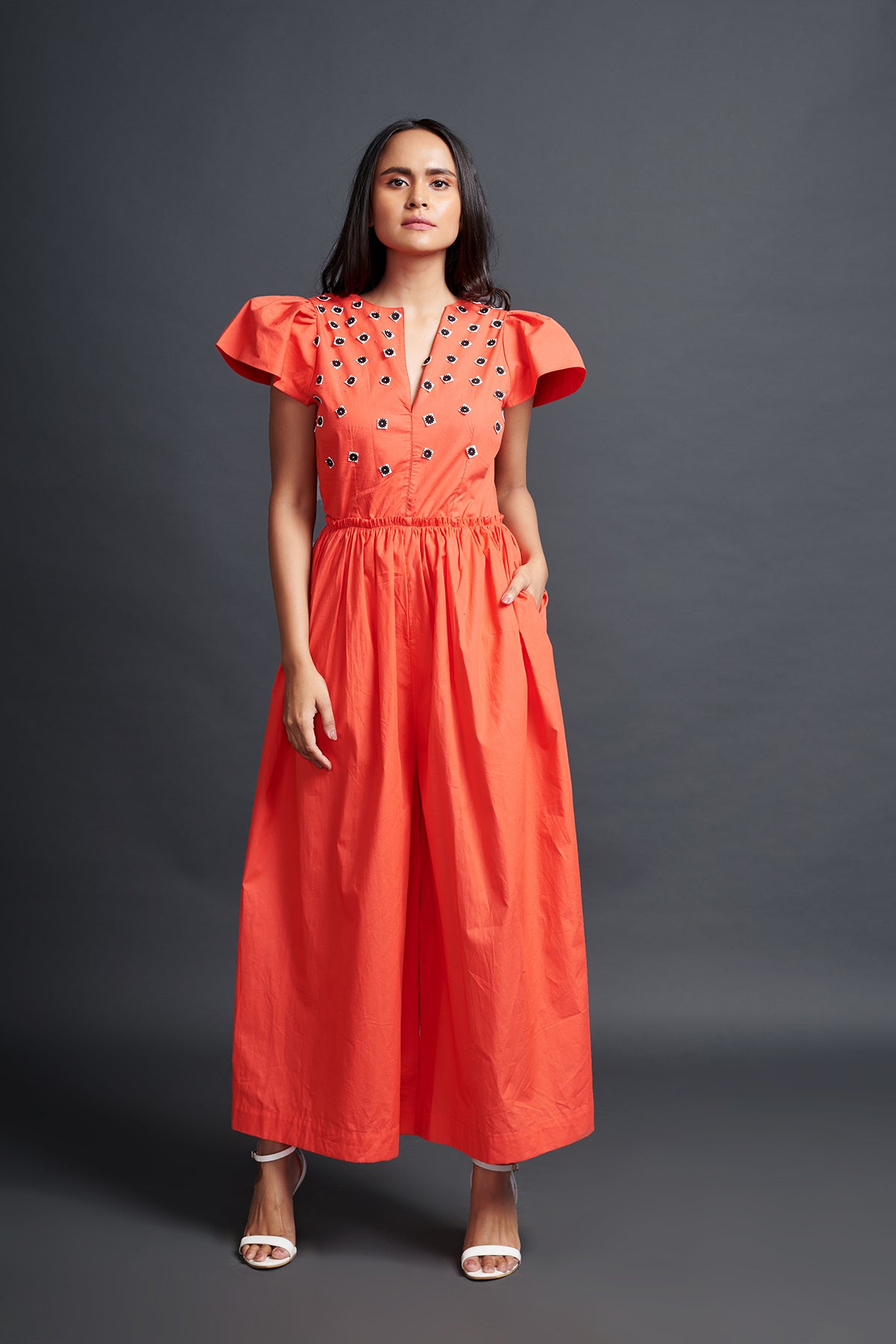 Image of ORANGE BACKLESS JUMPSUIT IN COTTON BASE WITH CUTWORK EMBROIDERY. From savoirfashions.com