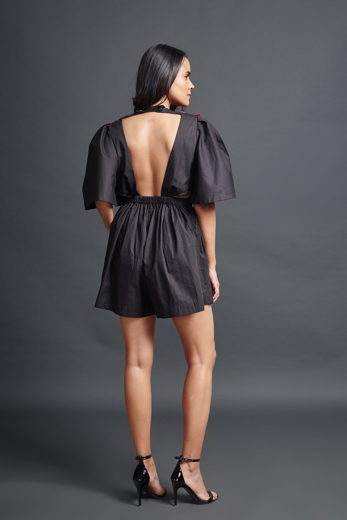 Image of BLACK PLAYSUIT IN COTTON BASE WITH CUTWORK EMBROIDERY AND BACKLESS SIDE CUT-OUT DETAIL. From savoirfashions.com