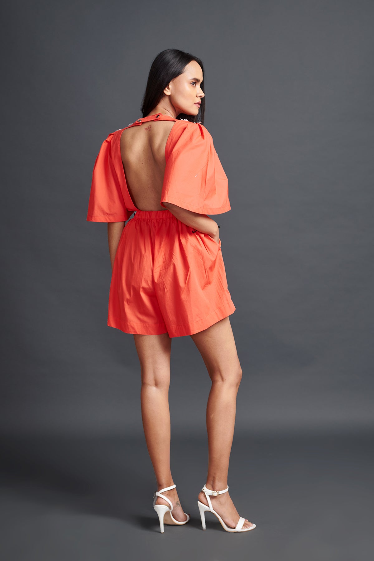 Image of ORANGE PLAYSUIT IN COTTON BASE WITH CUTWORK EMBROIDERY AND BACKLESS SIDE CUT-OUT DETAIL. From savoirfashions.com