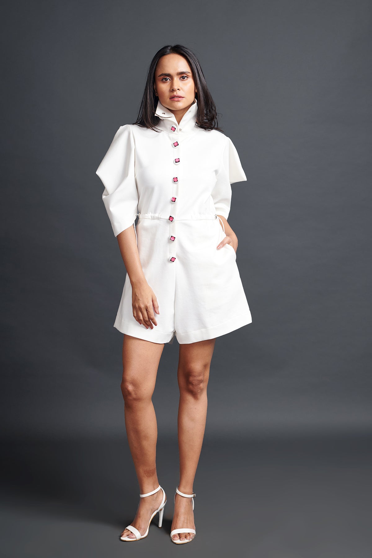 Image of WHITE HIGH NECK PLAYSUIT WITH CUT WORK NEON BUTTONS. From savoirfashions.com