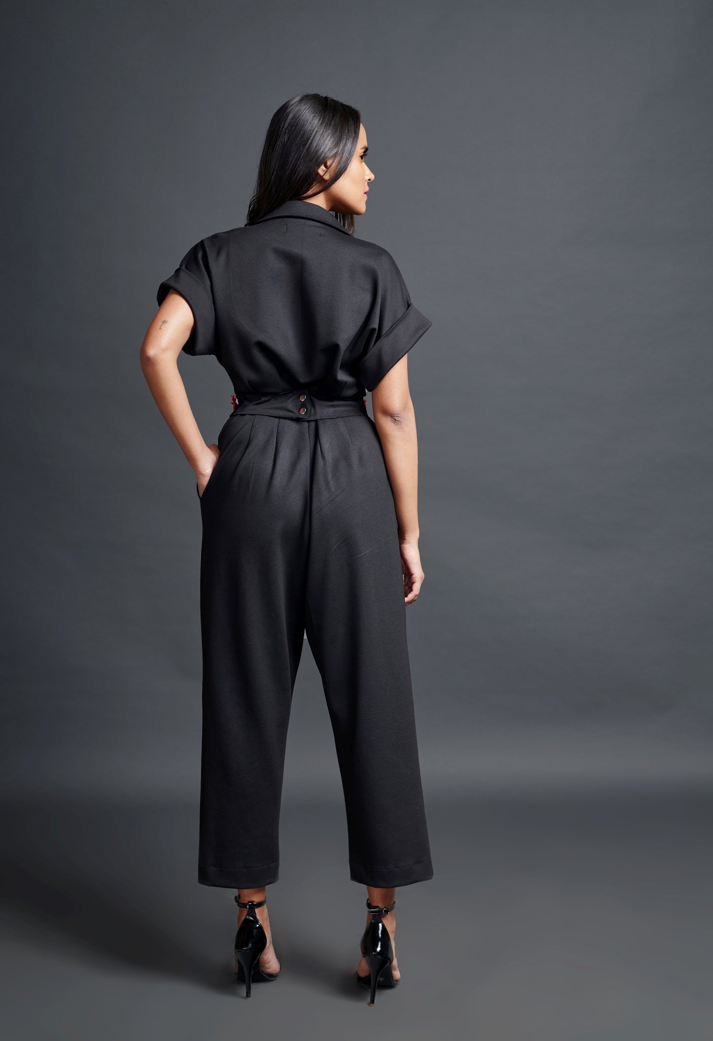 Image of BLACK COLLARED JUMPSUIT WITH NEION CONFETTI BELT. From savoirfashions.com