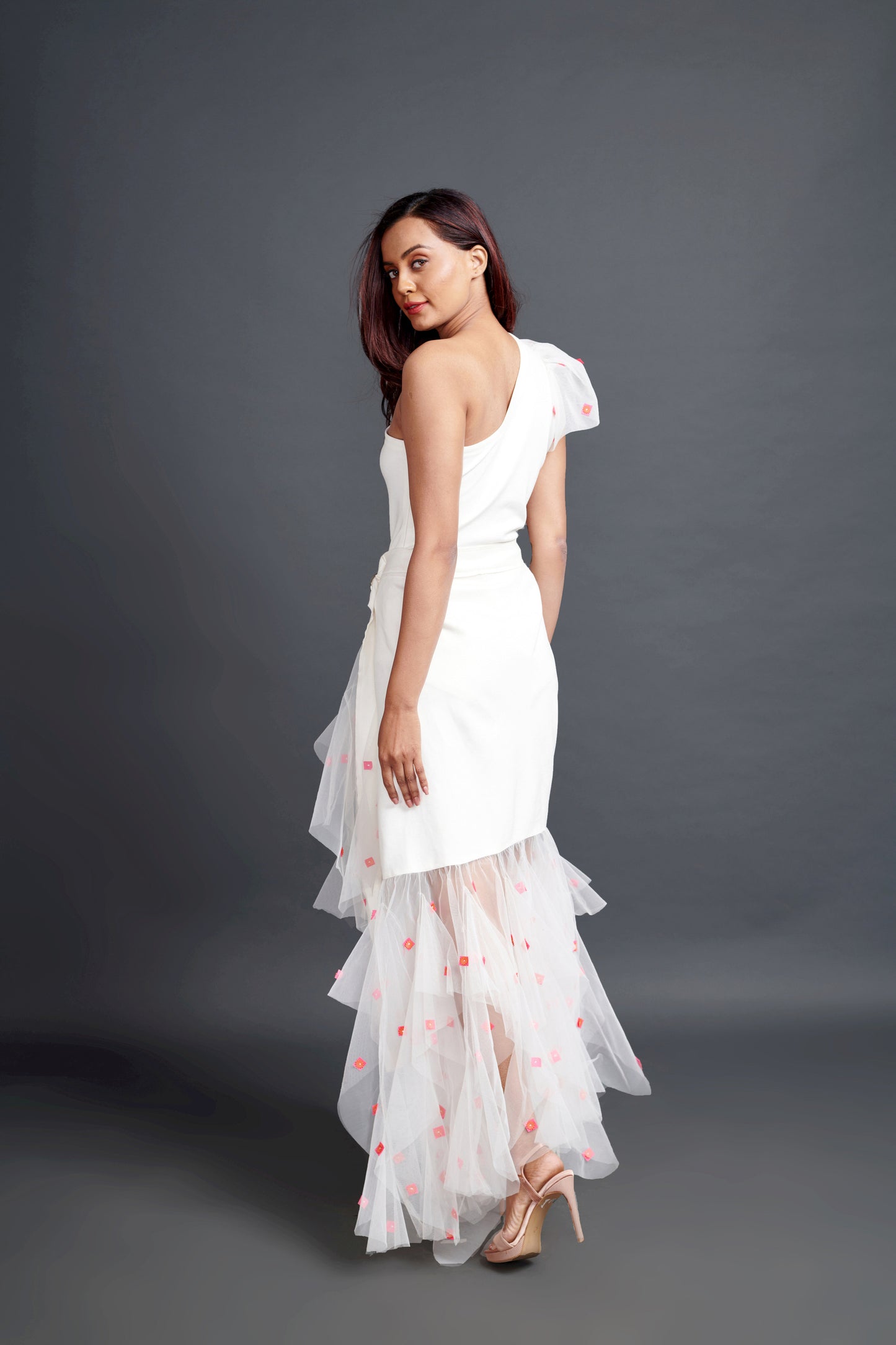 Image of WHITE ONE SHOULDER BODY SUIT WITH CONFETTI DETAILING ON A HIGH-LOW LONG SKIRT. From savoirfashions.com