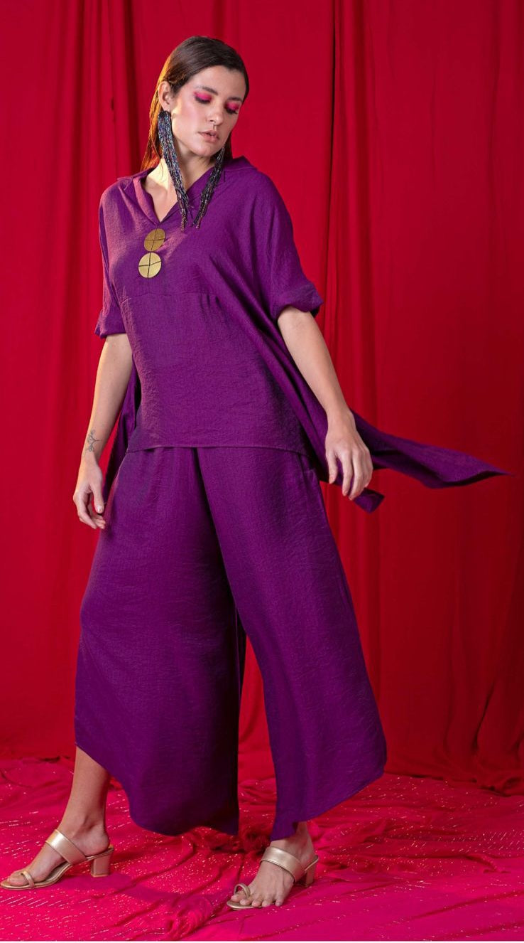 Image of This Purple Handkerchief Twin Set Kimono Top with a Bias Panel is embellished with large metallic coins and paired with an asymmetric Palazzo Pant for a modern look. The intricate detail and combination of materials make this an elegant, stylish ensemble perfect for any special occasion.  From savoirfashions.com