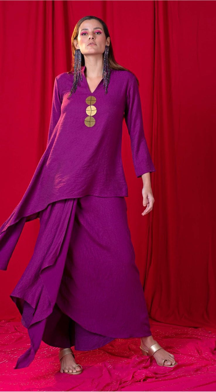 Image of This Purple Asymmetric Tunic Twin Set is a stunning yet sophisticated fashion statement. The metallic coins adorn the twin set and the draped skirt creates a graceful silhouette. Feel glamorous and show-stopping in this unique ensemble.  From savoirfashions.com
