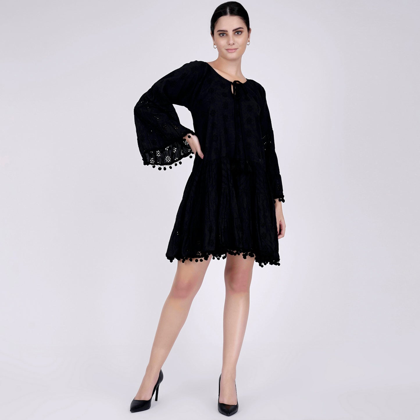 Image of Look stylish and confident while wearing the BLACK EYELET DRESS. Crafted from a high-quality eyelet fabric, this dress exudes a modern silhouette and a luxurious texture. The dress is designed to have a perfect fit, showing off your curves in the best light. Enjoy the quality and the timeless design of the BLACK EYELET DRESS.  From savoirfashions.com