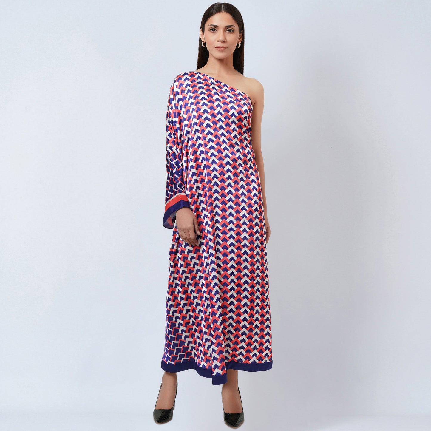Image of Turn heads with this stunning one-shoulder dress. The unique combination of coral pink and blue in a geometric print makes it a fashionable wardrobe essential. The lightweight fabric provides breathable comfort and the one-shoulder design adds an element of modernity.  From savoirfashions.com