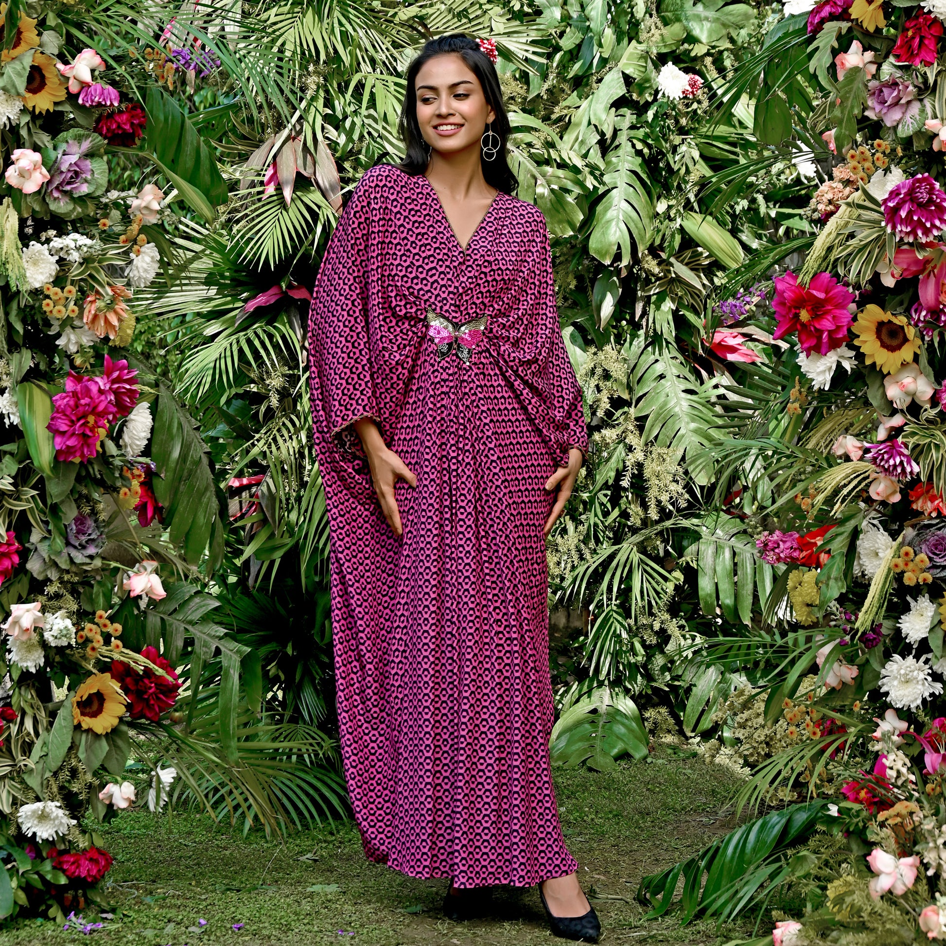Image of Look stunning in this MAGENTA HONEYCOMB PRINT SILK FULL LENGTH KAFTAN WITH BUTTERFLY MOTIF from our Kaftan Collection. Crafted from lightweight silk, this full-length kaftan is decorated with an intricately patterned honeycomb print and a delicate butterfly motif. It's sure to elevate your formal wardrobe. From savoirfashions.com