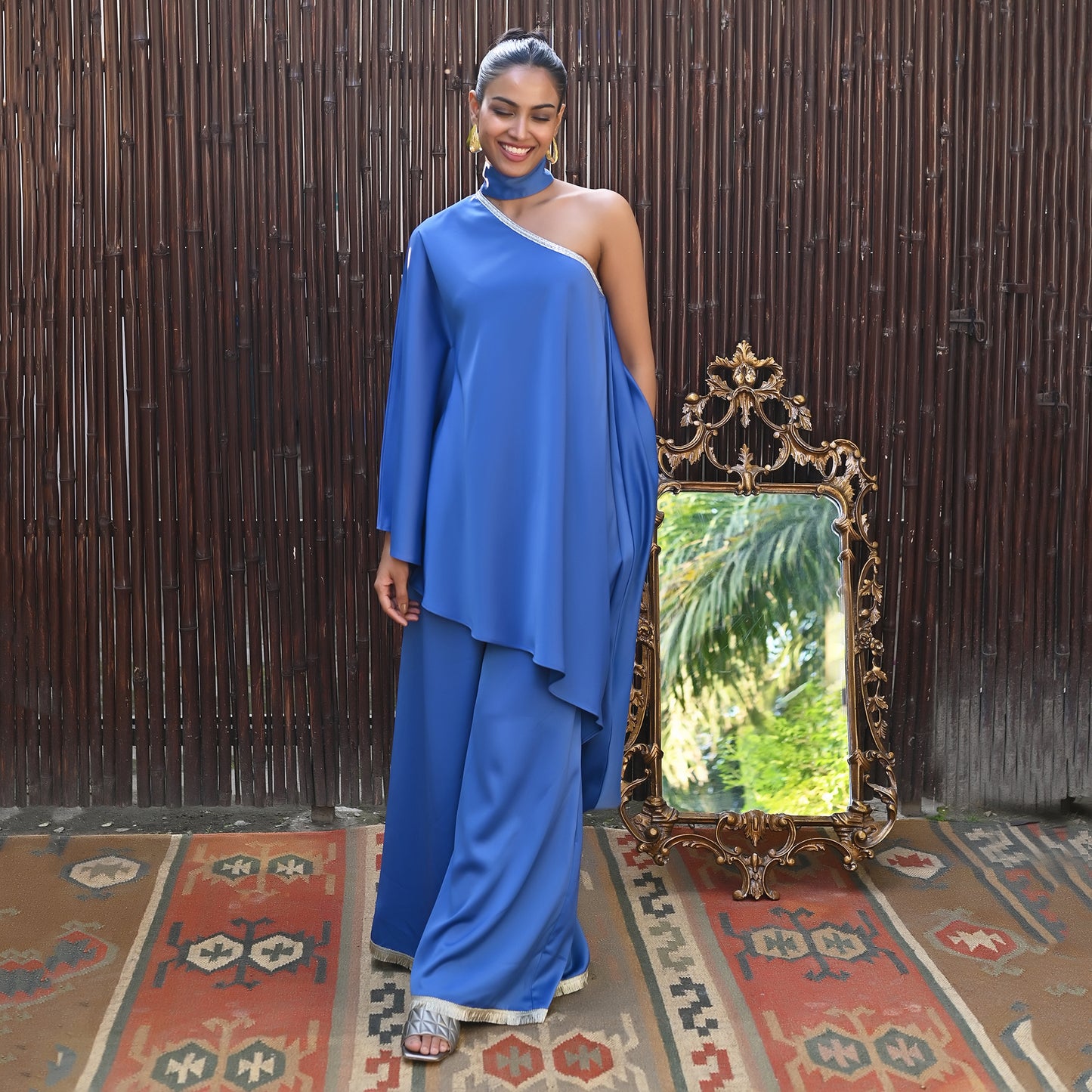 Image of This BLUE ONE-SHOULDER ASYMMETRIC TUNIC AND WIDE LEG PANTS set from our collection features a unique one-shoulder tunic and wide-leg pants. This eye-catching set is ideal for making a statement with its asymmetrical style and timeless design. From savoirfashions.com