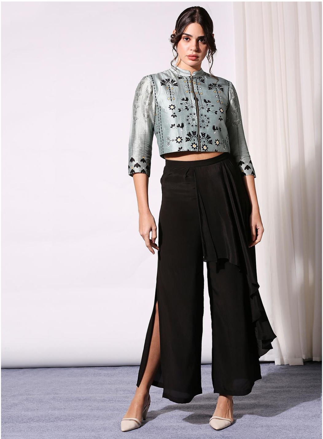 Image of This unique set is perfect for any special occasion. Crafted from a lightweight and breathable blend, the crop top features a classic round neckline and a short length for a modern silhouette. The palazzo pants add a touch of drama with a wide leg and statement waistband. Both pieces can be dressed up or down for limitless style possibilities.  From savoirfashions.com