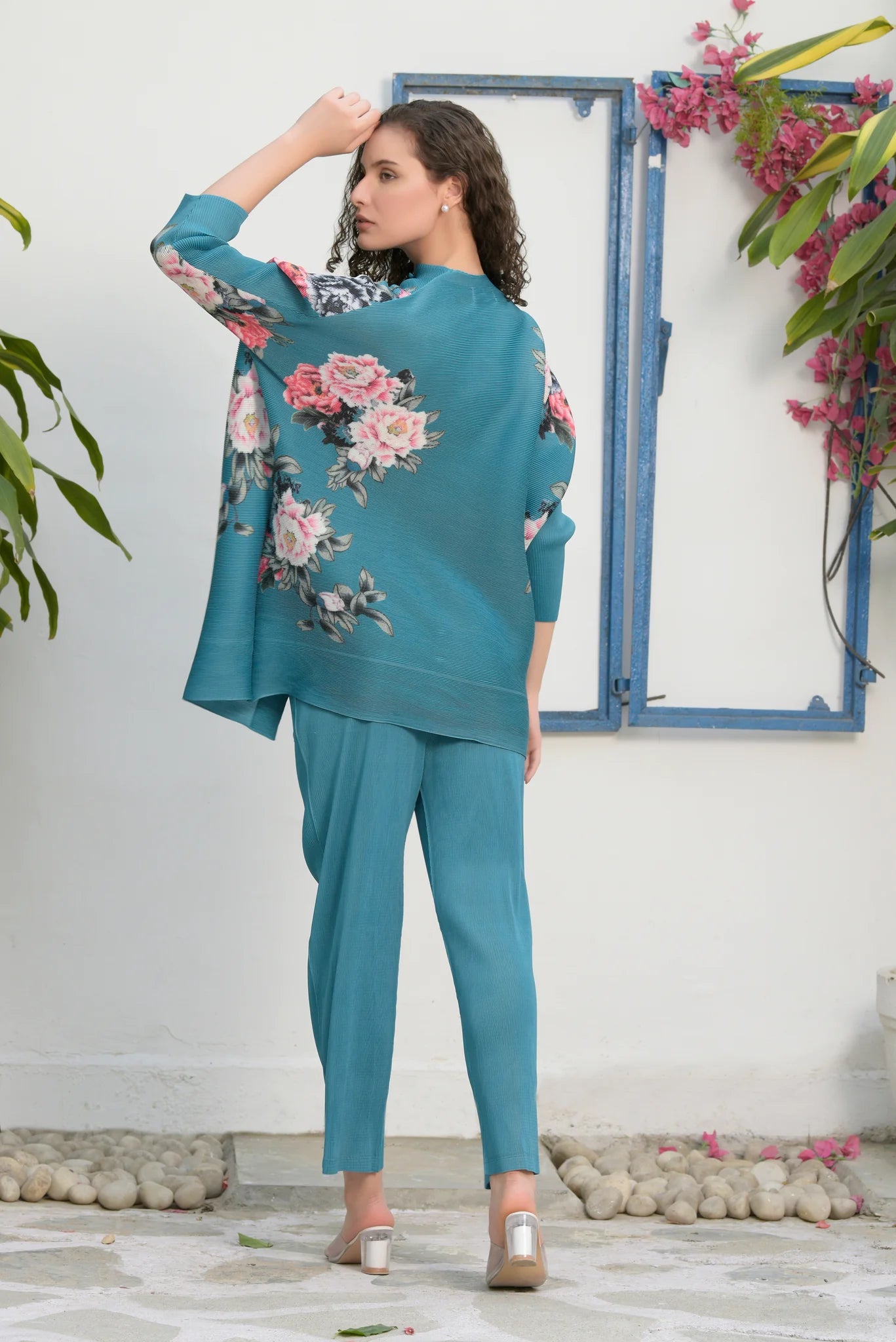 Image of This FAIRLIE FLORAL SHIRT WITH PLEATED PANTS - TEAL set is designed with quality in mind. Its 100% polyester fabric is breathable, comfortable, and wrinkle-resistant. The pleated pants and floral shirt will keep you looking stylish and ready for any occasion. From savoirfashions.com