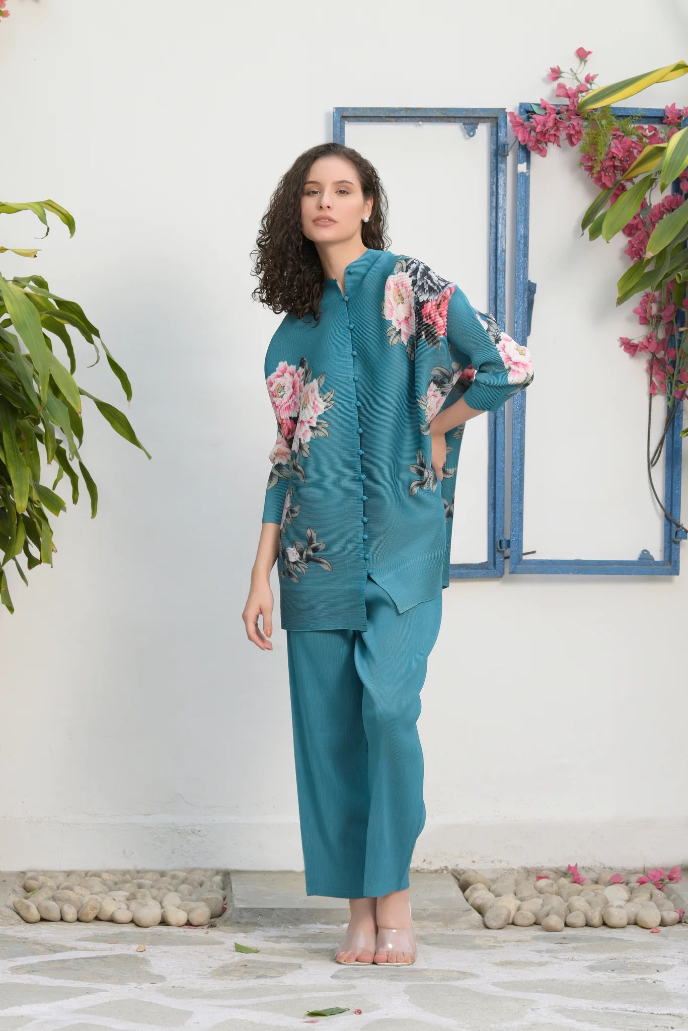 Image of This FAIRLIE FLORAL SHIRT WITH PLEATED PANTS - TEAL set is designed with quality in mind. Its 100% polyester fabric is breathable, comfortable, and wrinkle-resistant. The pleated pants and floral shirt will keep you looking stylish and ready for any occasion.  From savoirfashions.com